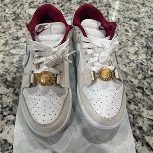 Nike White and Burgundy Low-Top Sneakers with Gold Medallion